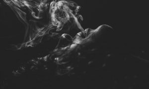 Black and white image of cigar smoking